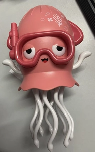 Close-up of pink dancing octopus toy with diving goggles and white tentacles