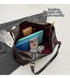 Deep brown leather tote interior showing large capacity for tablet and accessories