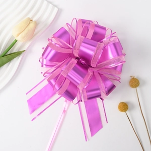Close-up of a purple metallic pull bow with mesh trim for elegant gift packaging