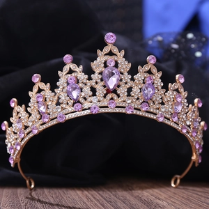 Macro shot of golden leaf tiara with purple teardrop crystals and clear rhinestones