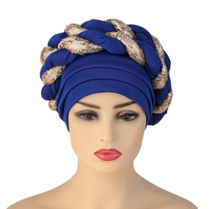 Royal blue turban cap with braided gold and blue sequins shown on a mannequin