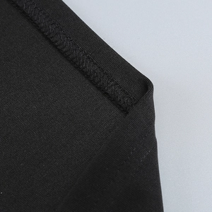 Close-up of black knitted elastic fabric with detailed overlock stitching and high texture