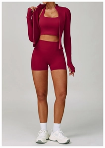 Three-piece berry red yoga set with zip jacket, sports bra and high-waist biker shorts
