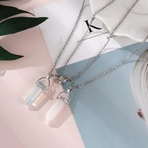 Detail of magnetic heart clasp with white and blue hexagonal stone column pendants