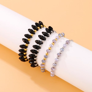 Four-piece beaded bracelet set with turquoise beads and metallic accents on display