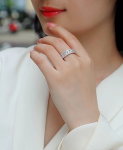 Detail view of multi-row S925 silver ring with moissanite stones on a finger