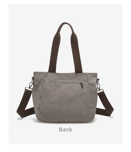 Rear view of grey canvas tote bag with back zipper pocket and adjustable shoulder strap