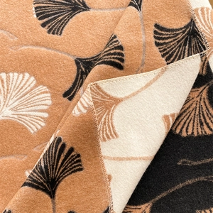 Detail shot of the soft ginkgo leaf pattern cashmere-like fabric with textured folds
