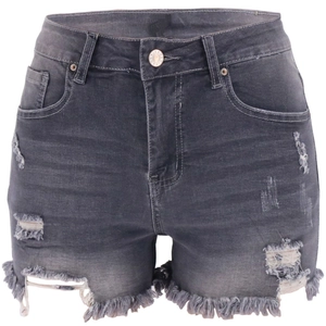 Detail view of grey denim shorts featuring distressed ripped holes and raw fringe hem