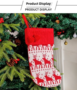 Close-up of a red and white knitted Christmas stocking with reindeer and snowflake motifs