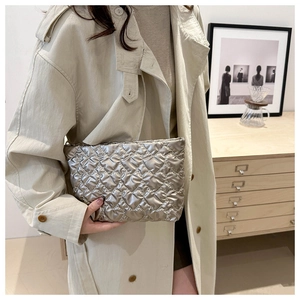 Close-up of silver quilted handbag with heart pattern shown in an elegant setting