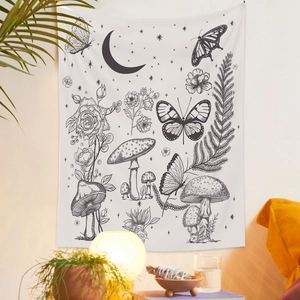 Detail of a butterfly and mushroom tapestry with black and white line art on a cozy wall