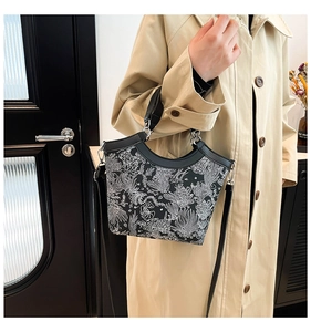 Detail of floral printed bucket bag with silver hardware and detachable shoulder strap