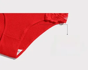 Detailed close-up of red ribbed cotton panties with delicate lace trim and mid-waist cut