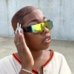 Y2K futuristic rimless sports sunglasses with green gradient lenses on a model