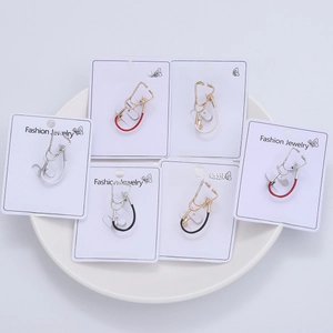 Detail view of fashion stethoscope brooches in gold and silver finish on display cards