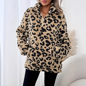Detail of leopard print fleece sweatshirt featuring half-zip collar and large front pocket