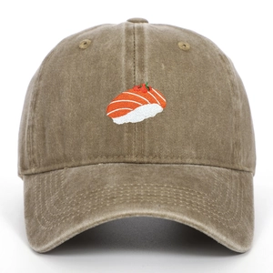 Close-up of salmon sushi embroidery on washed khaki vintage style baseball cap