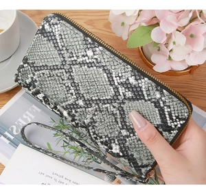 Detail of snake skin pattern long wallet with zipper closure and wrist strap