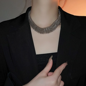 Detailed view of wide silver woven mesh collar necklace on model neck with industrial style