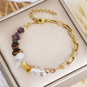 Gold chain bracelet with colorful natural crystal stone chips on champagne jewelry box
