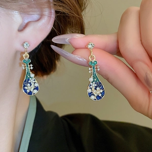 Elegant Chinese style lute earrings with enamel details and pearl accents on the ear