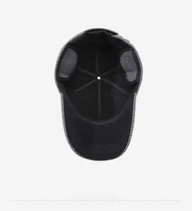 Internal view of dark grey plaid winter hat with ear flaps and black lining
