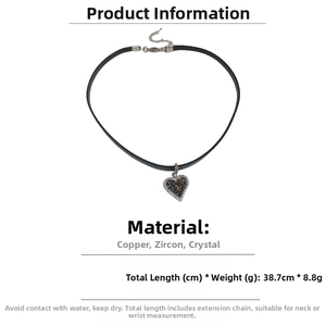 Detailed macro view of black leather choker with zircon heart pendant and lobster clasp