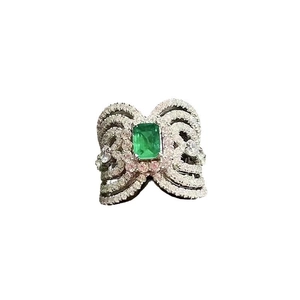 Luxe emerald green bow ring with pave micro-diamonds in polished silver setting