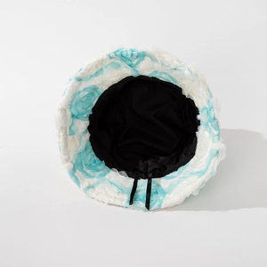 Plush floral bucket hat in white and blue featuring adjustable inner straps for fit