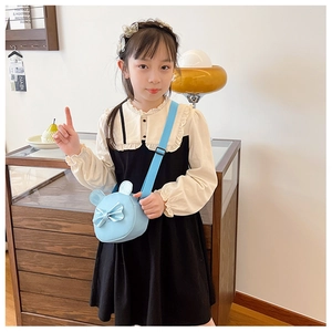 Detailed close-up of a blue PU leather kids crossbody bag featuring cute ears and a bow