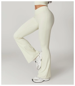 Detail of high waisted cross waist yoga flare pants in cream with premium texture