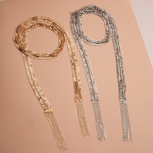 Exaggerated metal mesh tassel necklaces in gold and silver with rhinestone details