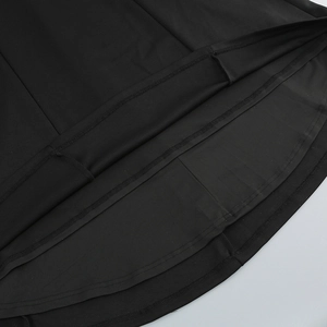Detail view of double-stitched hem and reinforced sewing on black fishtail dress