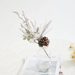 Artificial Christmas stems with white berries, snowy pine needles and a natural pinecone