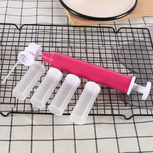 Manual cake airbrush set with four 35ml clear plastic containers on a black cooling rack