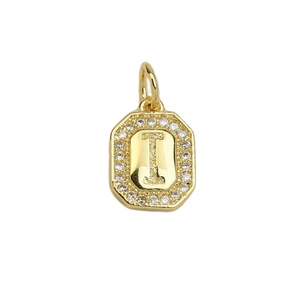 Detailed macro of a square gold pendant with letter I and zircon stones
