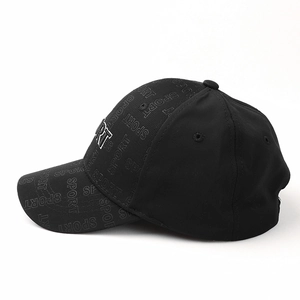 Detail of black baseball cap featuring 3D embroidered letters and sport pattern embossing