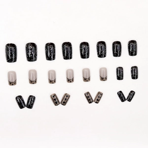 Starry black and pink glitter press-on nails with French tips and heart patterns