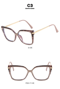 Detail view of C3 cat-eye glasses with amber tortoise frame and gold metal temples
