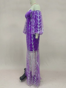 Detail of purple evening gown featuring silver glitter branch patterns and sheer tulle sleeves