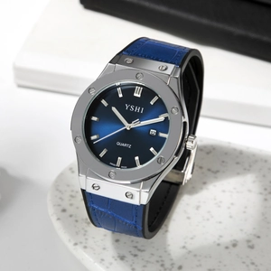 Detail of blue sunray dial with date window and silver bezel on leather strap watch