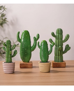 Set of four Nordic resin faux cactus ornaments with realistic texture on wooden table