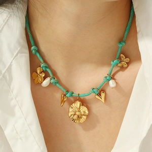 Bohemian braided necklace with turquoise cord, gold flower charms, shell and pearl