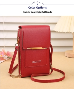 Macro detail of red leather phone bag with gold metal trim and zipper compartments