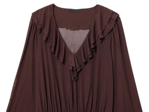 Detail of dark brown V-neck dress with elegant ruffle edges and chiffon fabric texture