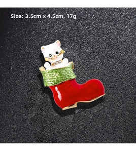 Detail view of Santa boot and kitten brooch showing 3.5cm x 4.5cm dimensions and rhinestones
