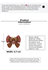Detailed view of luxury moth brooch with red rhinestones and 5.9cm x 6.7cm dimensions