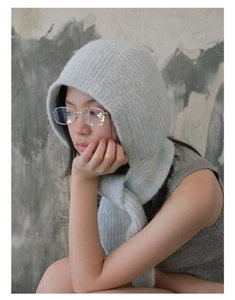 Close-up of soft light blue knitted balaclava hood with delicate woven texture details