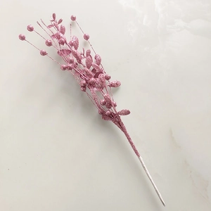 Macro detail of pink glitter Christmas berry pick on light marble background